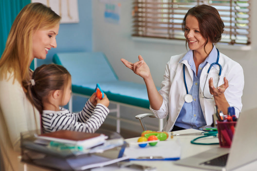 Female pediatrician with child